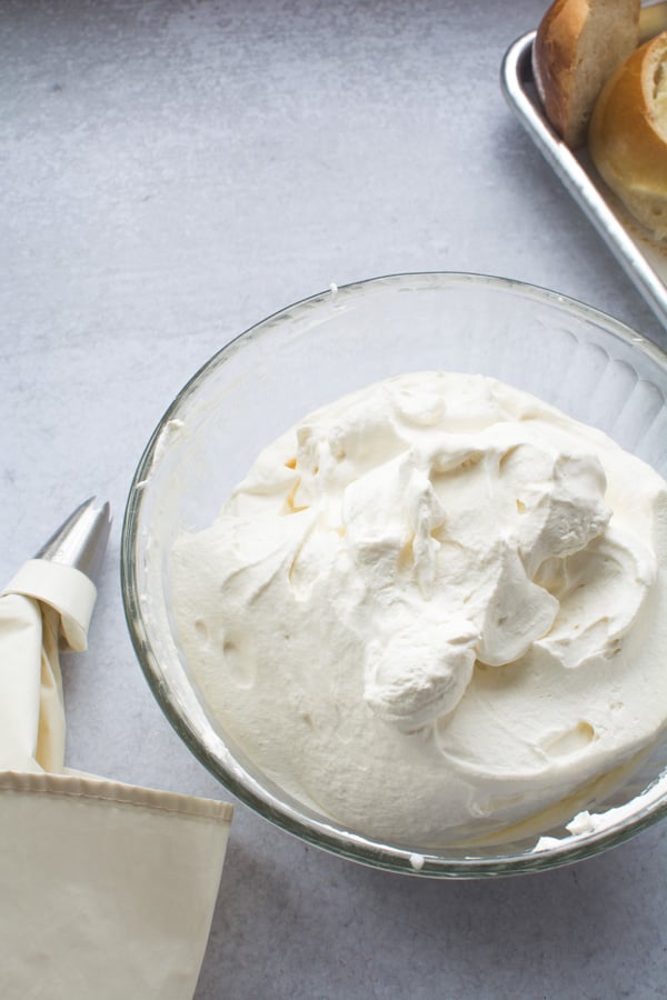 Glass bowl filled with homemade whipped cream.