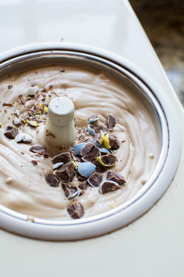 chocolate ice cream in churn with chopped cadbury eggs on top