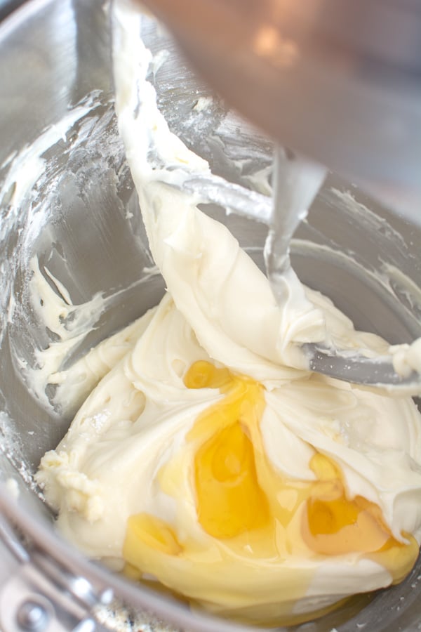 Cream cheese icing with honey in mixing bowl