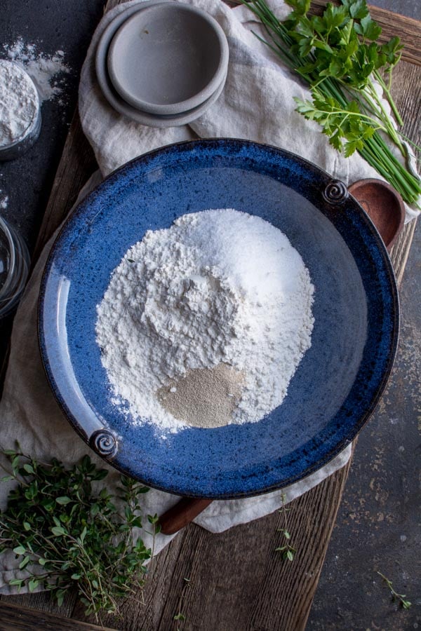 blue bowl with flour, sugar, yeast