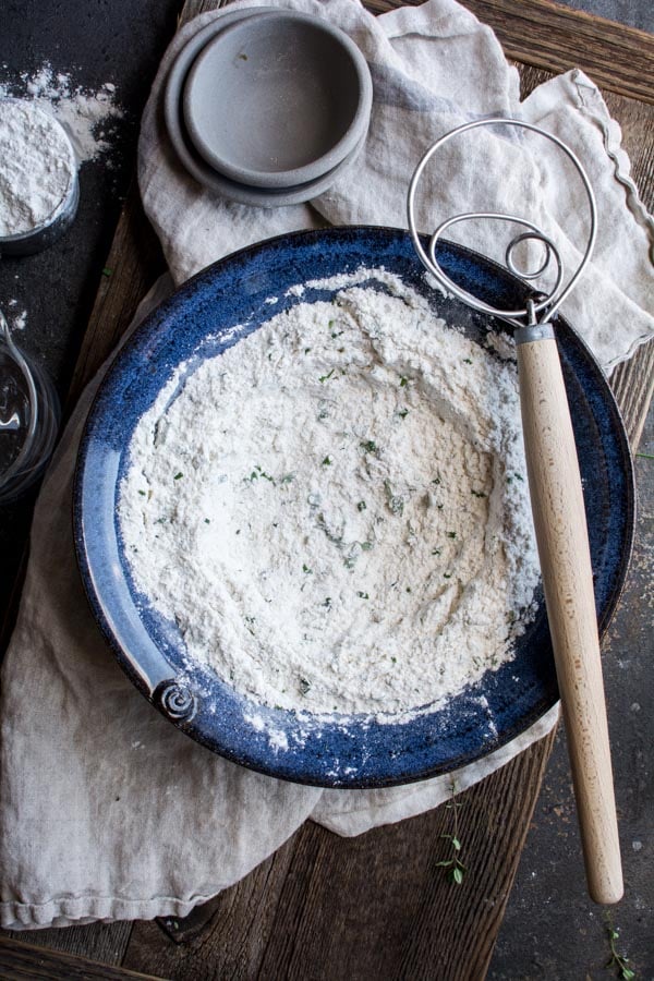 blue bowl with flour and herb mixture