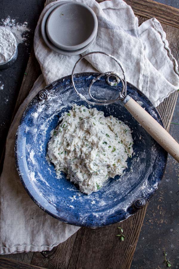 mixed focaccia dough in blue bowl with dough whisk