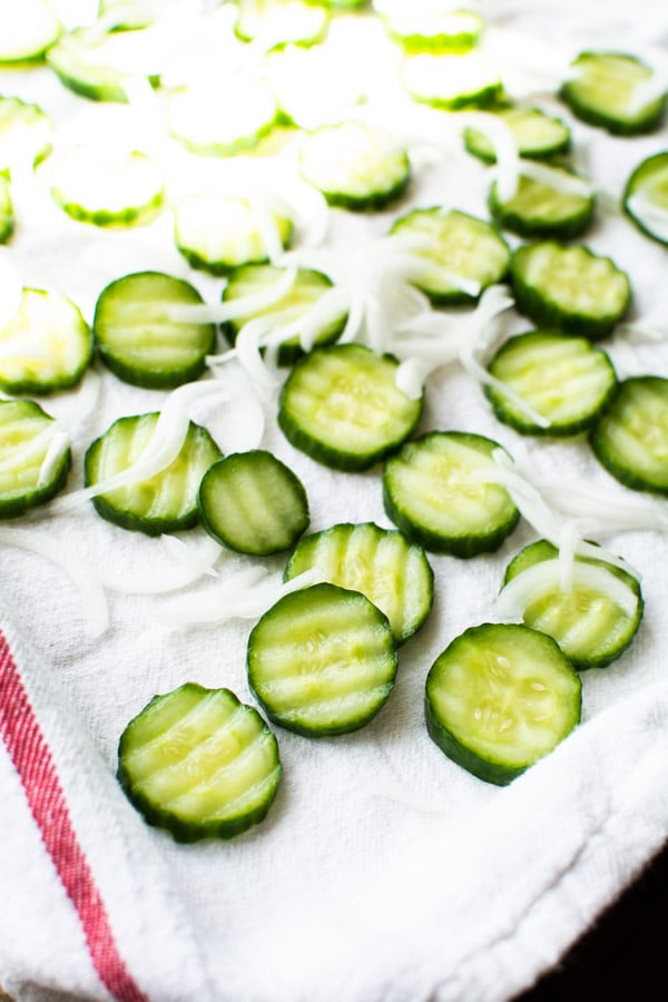 cucumber slices and onions on white cloth