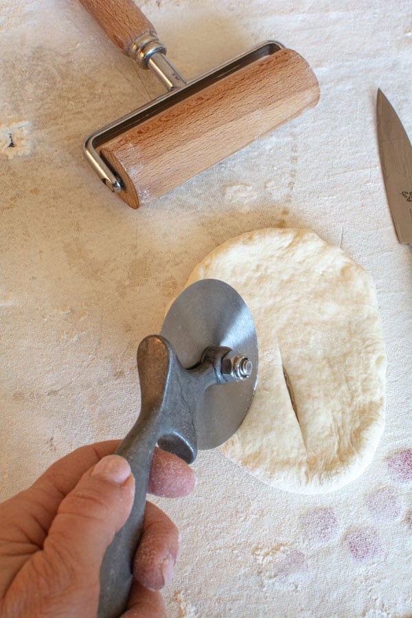 Flattened dough cut with pizza cutter