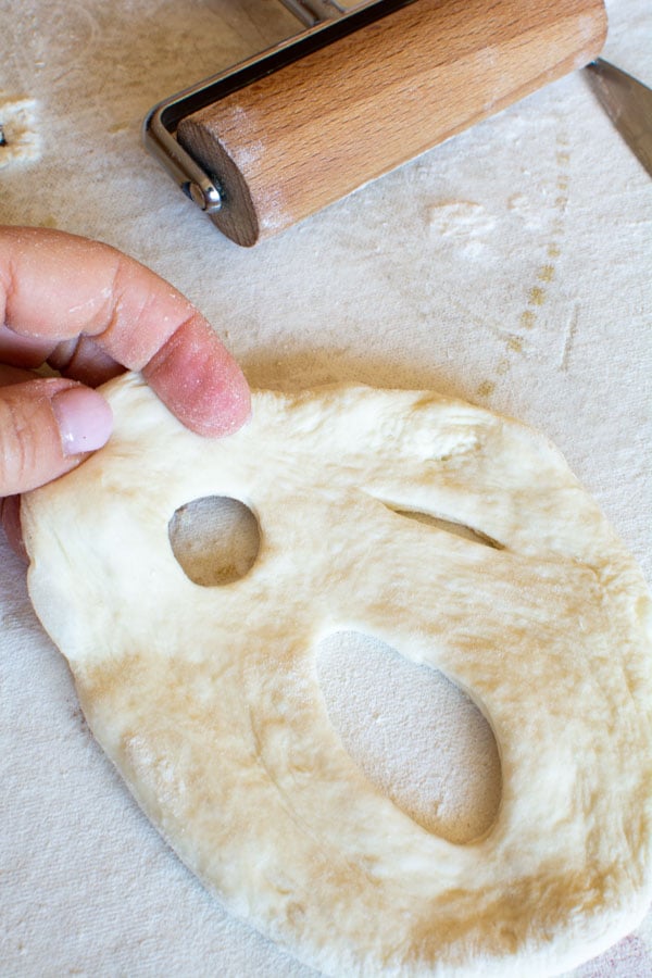 hand stretching ghost fougasse into shape