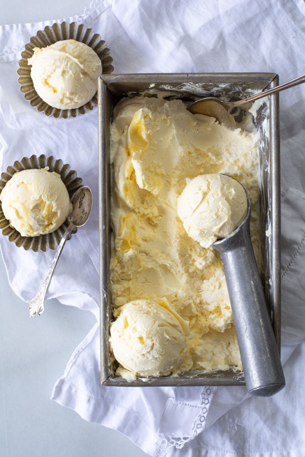 pan of frozen lemon curd ice cream with ice cream scoop