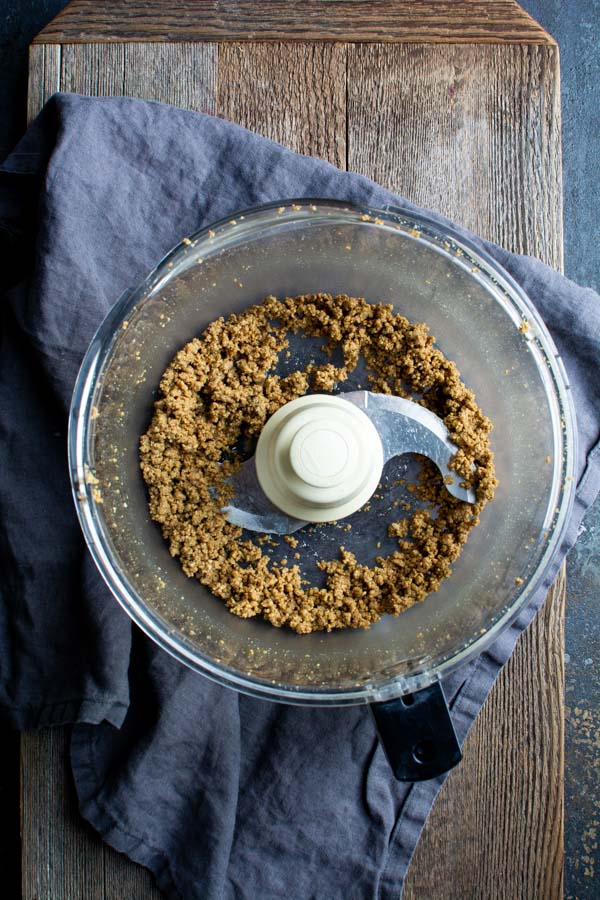 food processor bowl with ground pumpkin seeds