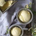 a scoop of homemade vanilla ice cream in two gray bowls