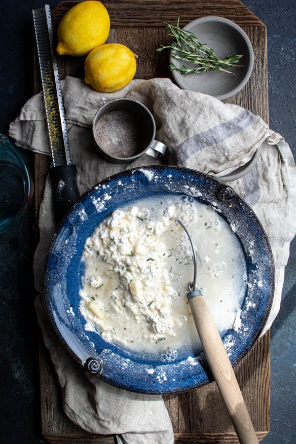 Blue bowl with flour mixture and water poured over top