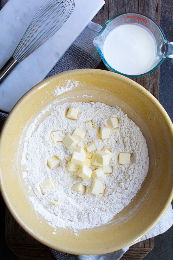 Large bowl with biscuit flour mixture cutting in butter