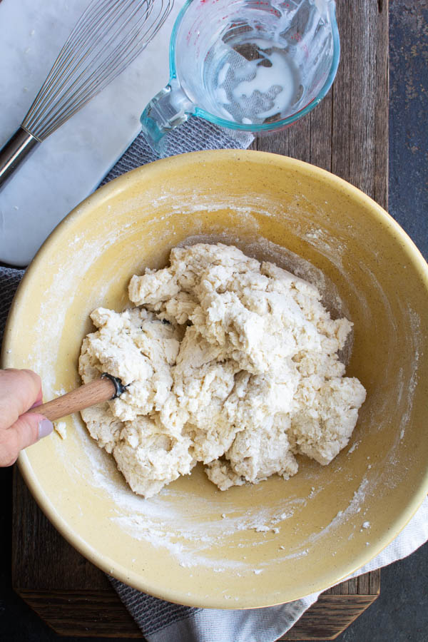 Large bowl with spatula mixing in dough.