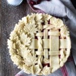 Decorative lattice on cranberry peach pie, sanding sugar, and cranberries