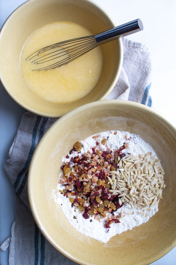 Large bowl with flour, dried fruit, candied citrus peel and almonds.