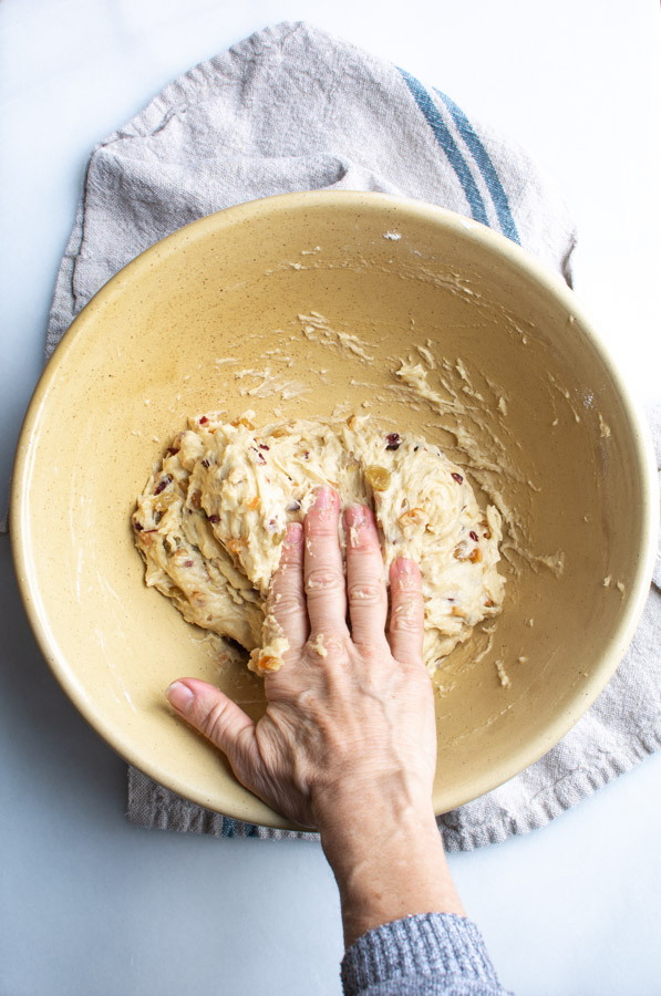 Stollen dough with hand folding dough into center