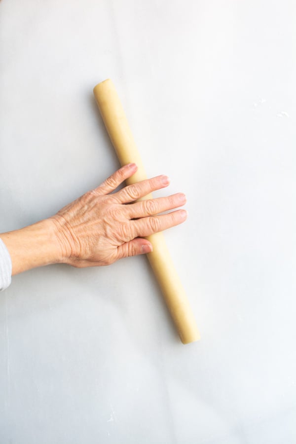 Hand rolling a log of marzipan