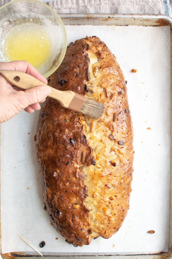 Brushing baked Stollen with butter.