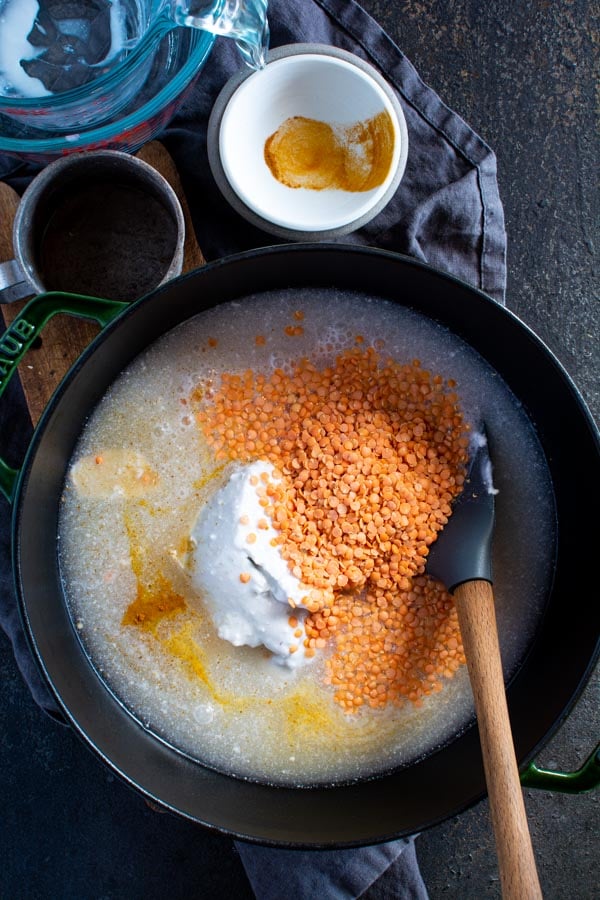Large pot with red lentils, coconut milk, water, and turmeric