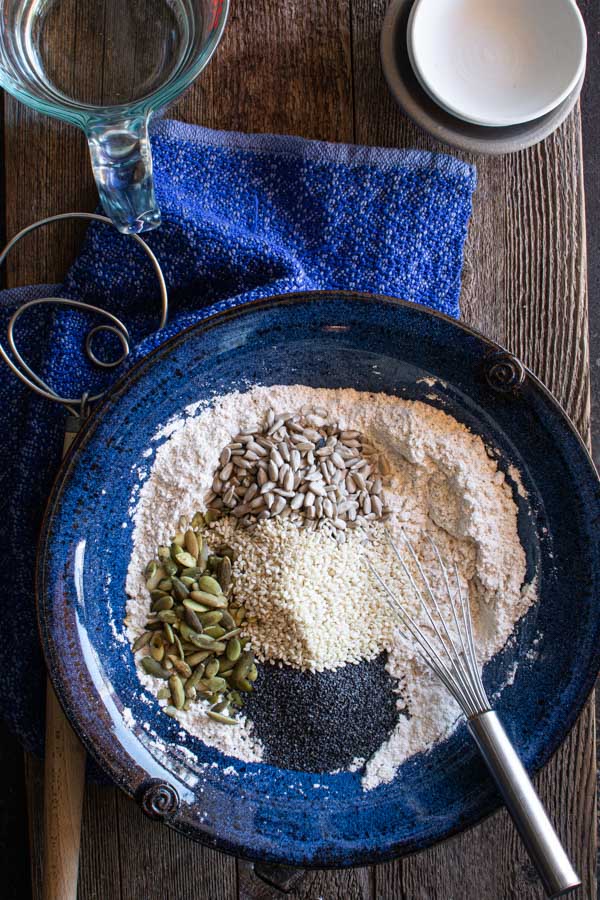 Large bowl with flour and , pumpkin seeds, sesame seeds, sunflower seeds, and poppy seeds