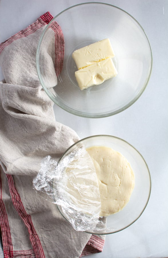 white chocolate roux in a bowl with soften butter in another bowl