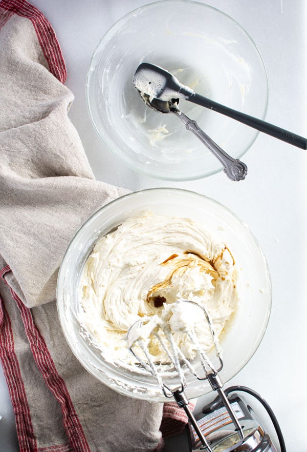 Bowl of whipped white chocolate icing with vanilla on top