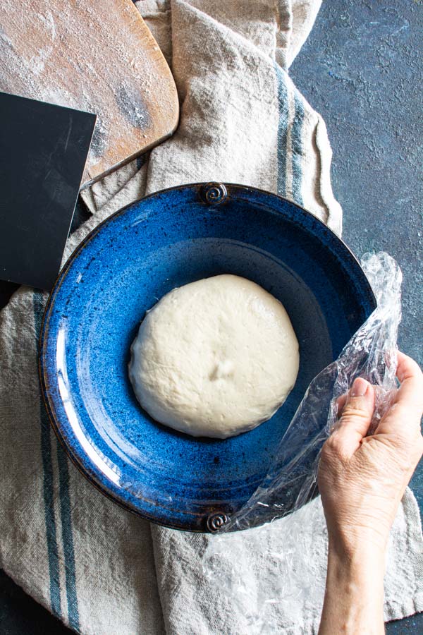Large blue bowl with paratha dough