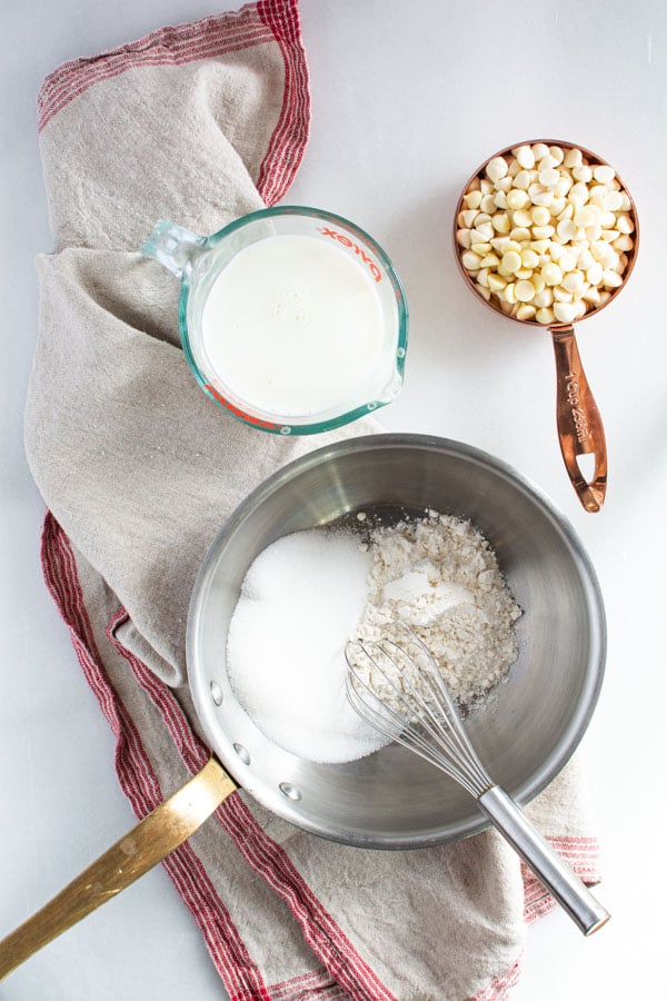 saucepan with sugar and flour and whisk