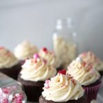 Chocolate cupcakes iced with fluffiest white chocolate icing with valentine sprinkles