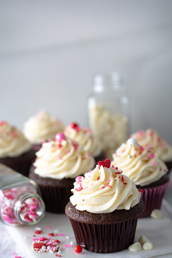 Chocolate cupcakes iced with fluffiest white chocolate icing with valentine sprinkles