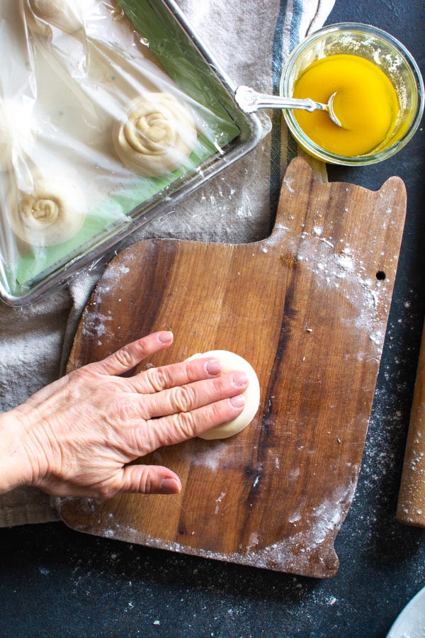 Hand pressing paratha dough into flat disk