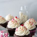 Chocolate cupcakes iced with fluffiest white chocolate icing with valentine sprinkles