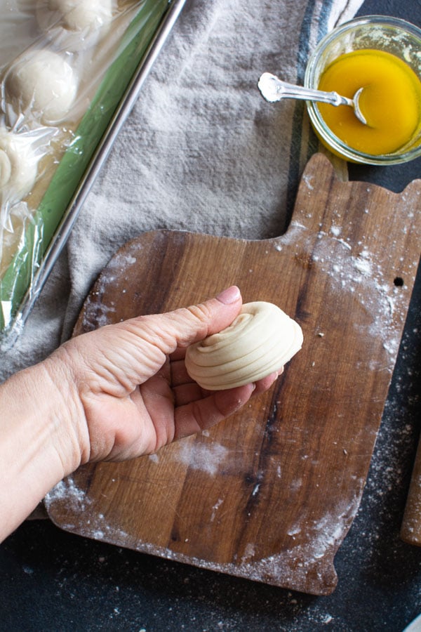 Side view of round layered paratha dough