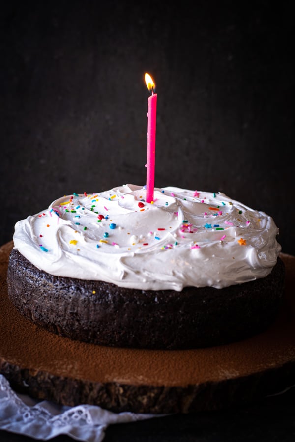 Lit candle on top of Old Fashioned Devil's Food Cake with Boiled Icing