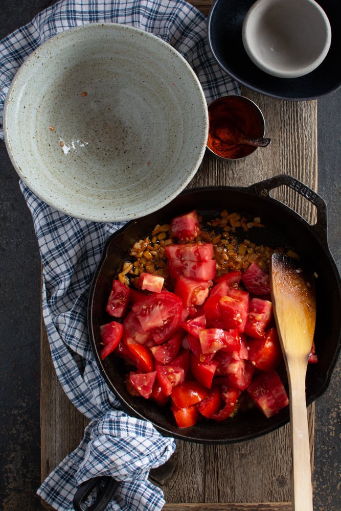 Chopped tomatoes added to sauteed onions in large skillet