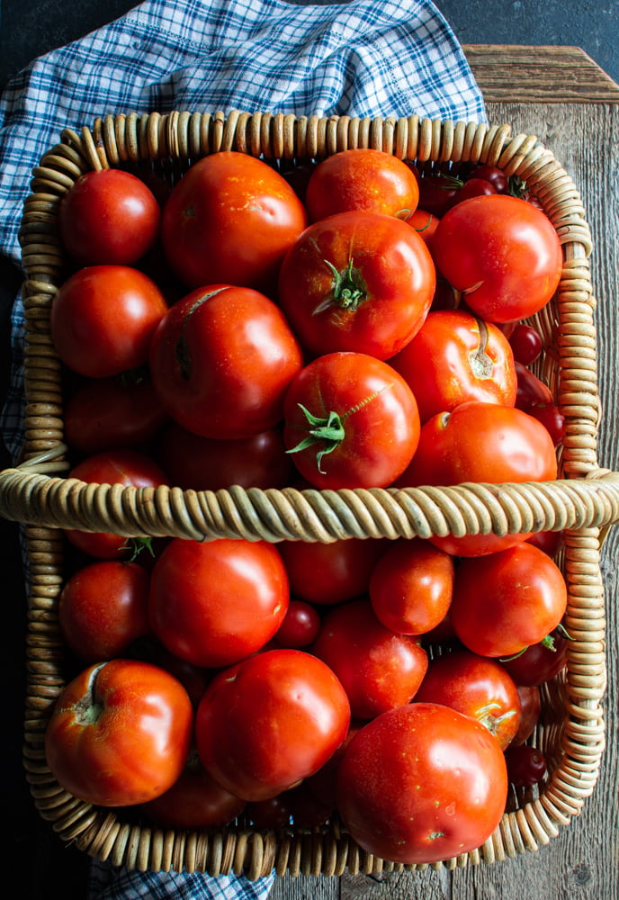 Large basket filled with red tomatoes