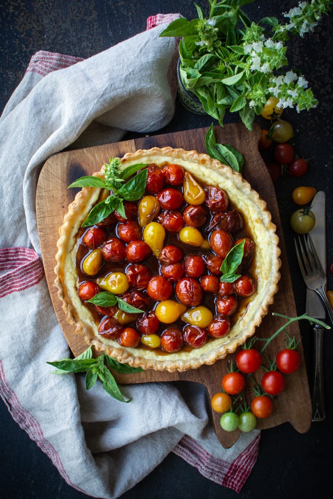 Baked ricotta tart topped with jammy cherry tomatoes.