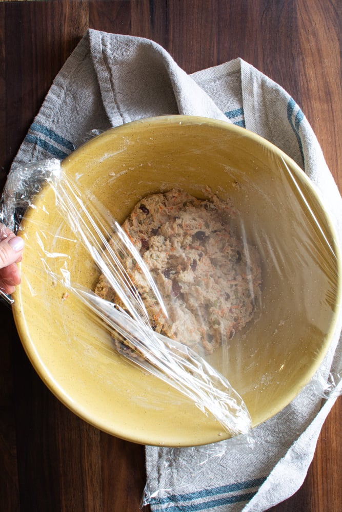 Plastic wrap covering mixed dough.