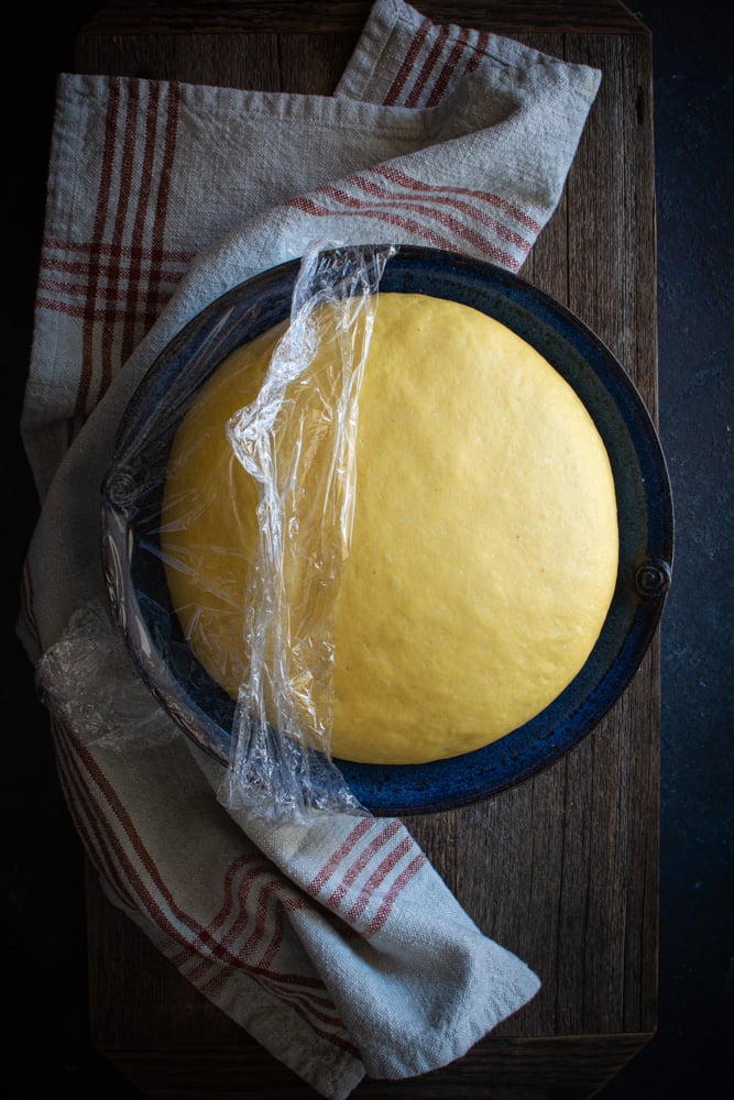 Large bowl with risen pumpkin bun dough