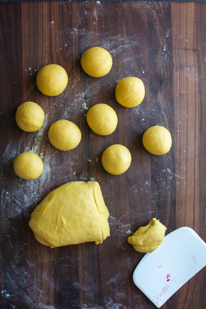 Round balls of pumpkin dough on a cutting board