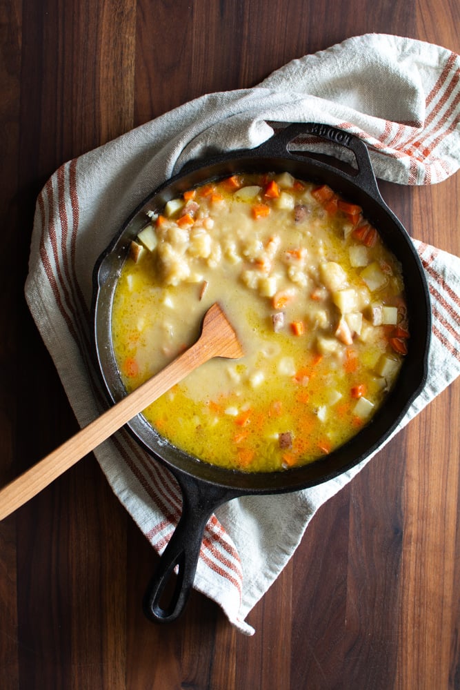 Roux added to skillet with chicken broth and sautéed veggies.