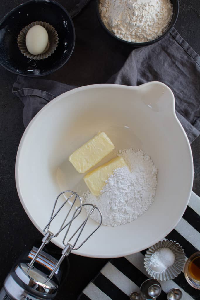 Butter and powdered sugar in a white bowl.