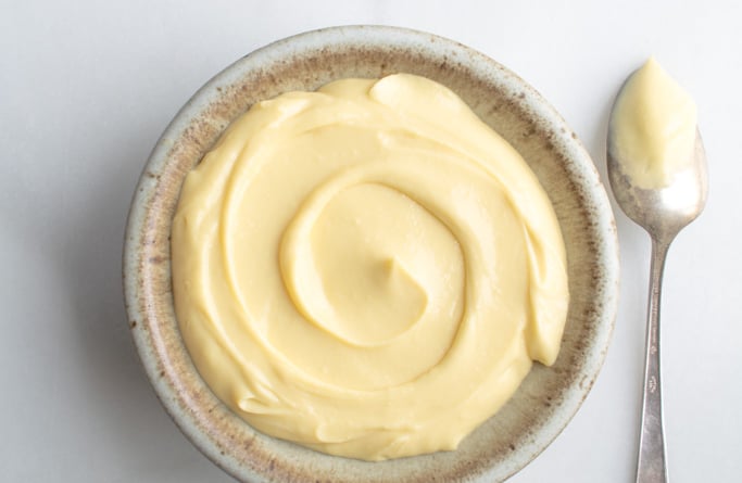 Velvety Vanilla pastry cream in a bowl with a spoon