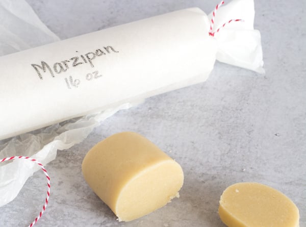 sliced marzipan wrapped roll in background