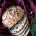 overhead shot of sliced cranberry orange pecan bread on a burgundy cloth