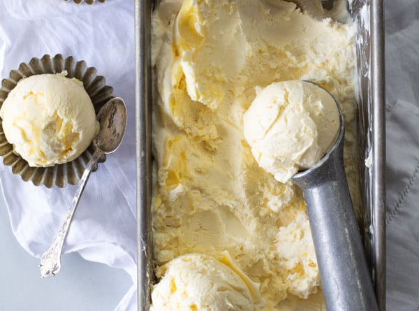 pan of frozen lemon curd ice cream with ice cream scoop