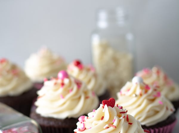 Chocolate cupcakes iced with fluffiest white chocolate icing with valentine sprinkles