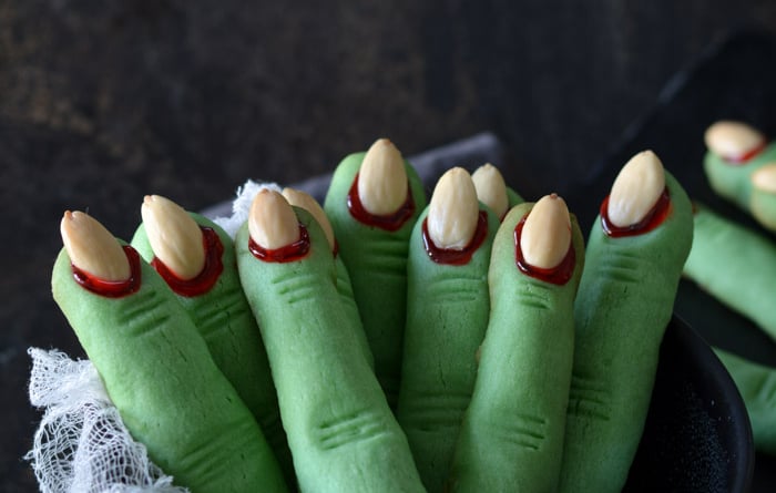 green Witch Finger Cookies standing in a black bowl