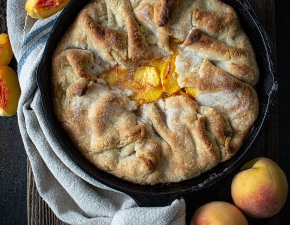 Baked southern peach cobbler in cast iron skillet