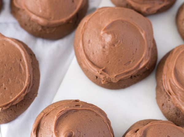 Several chocolate drop cookies on white background