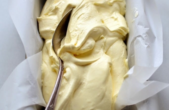 Lemon Curd Ice Cream in bread pan with spoon